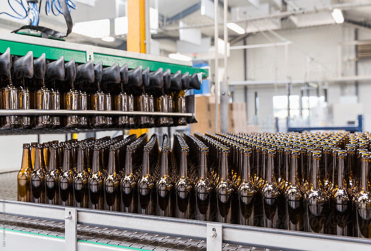 Empty beer bottles loading on to factory assembly line