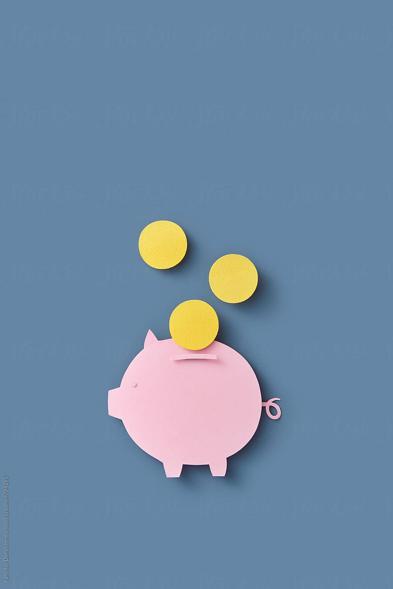 Pink papercraft piggy bank and yellow coins.