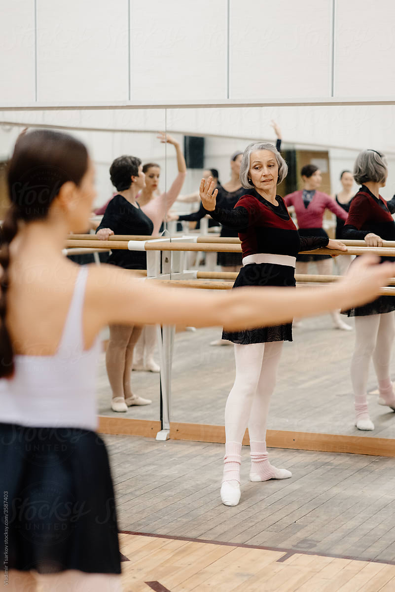 Ballet instructor showing exercise to group of mature women