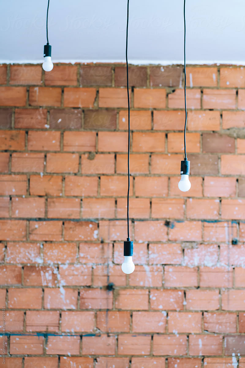 Light bulbs hanging on a brick wall