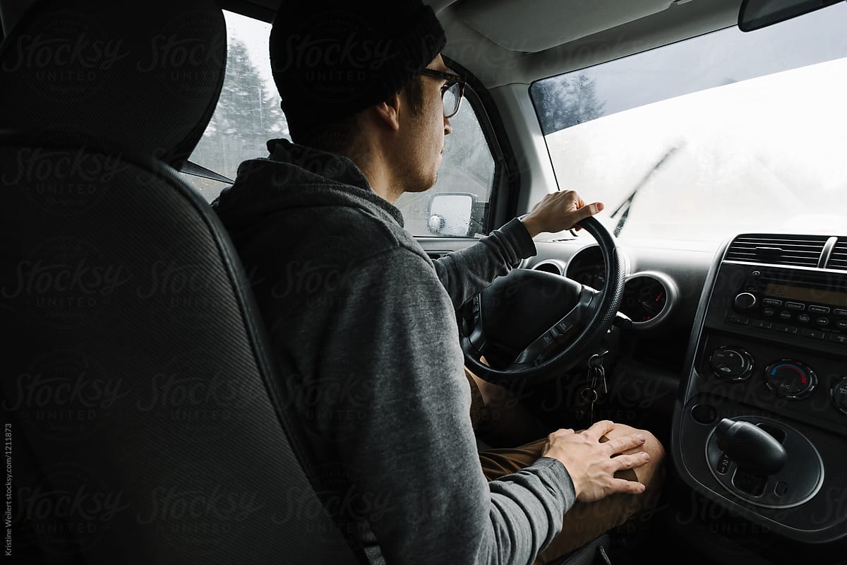 Interior view of car with man behind wheel