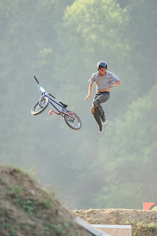 Male teenager doing extreme stunts with BMX