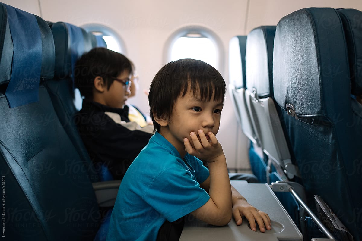 Young boy impatiently waiting for the airplane to takeoff