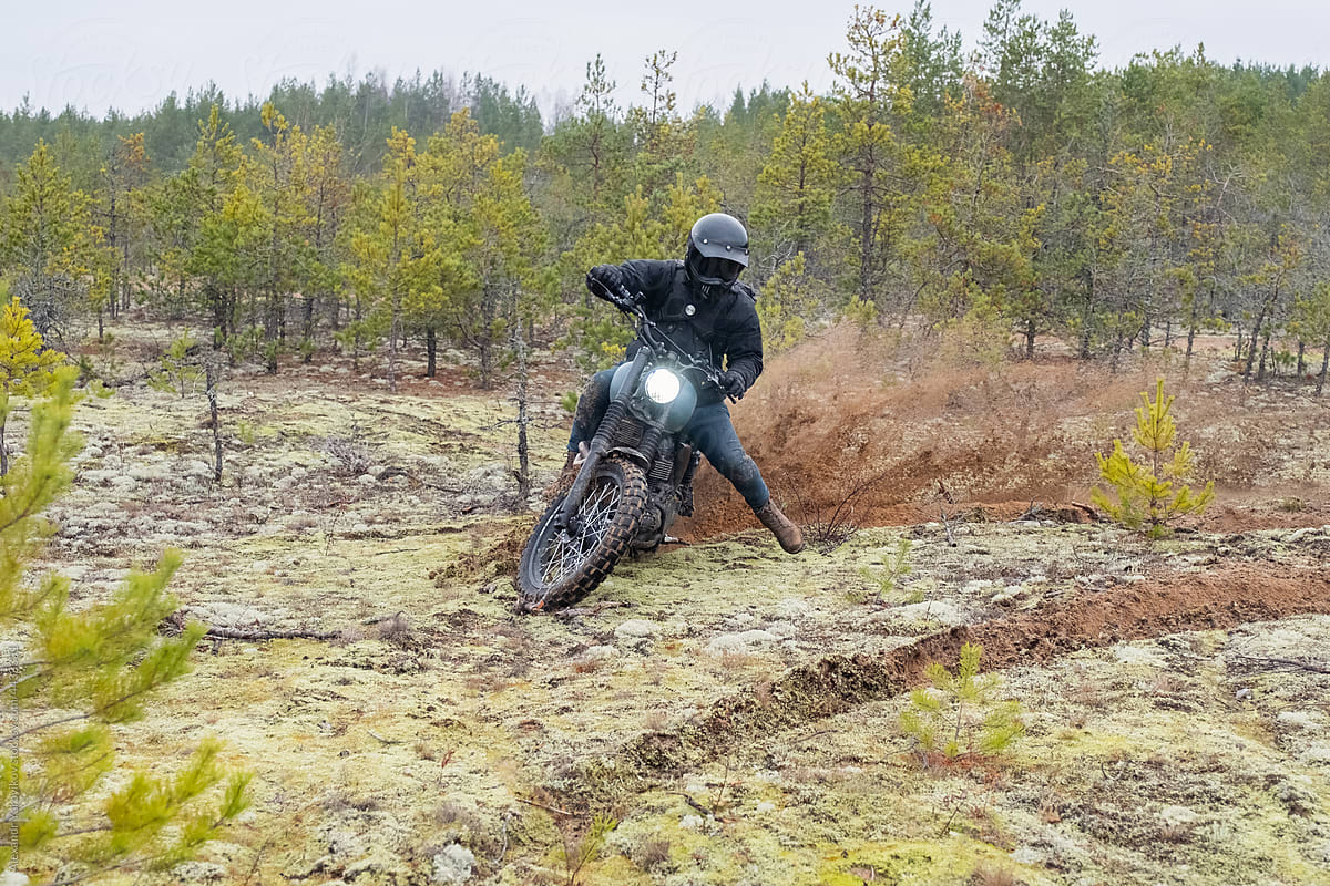 A rider on a motorcycle rides in a skid