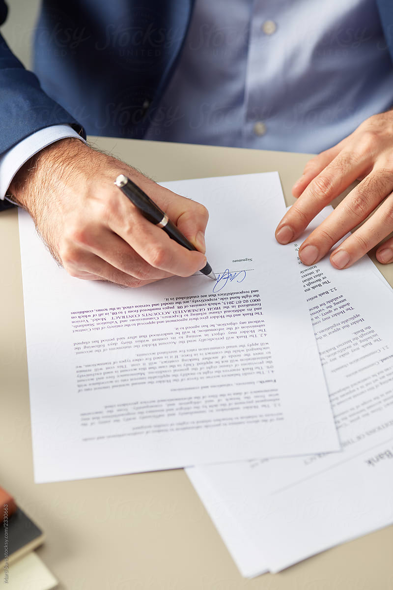 Man putting personal signature on paper
