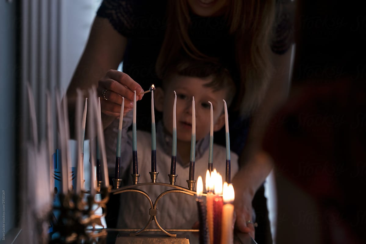 Hanukkah: Parent Helps Child Light Menorah
