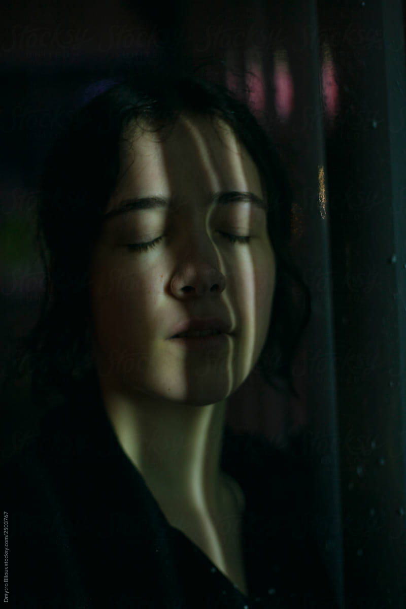 portrait of a girl in the dark with eyes closed