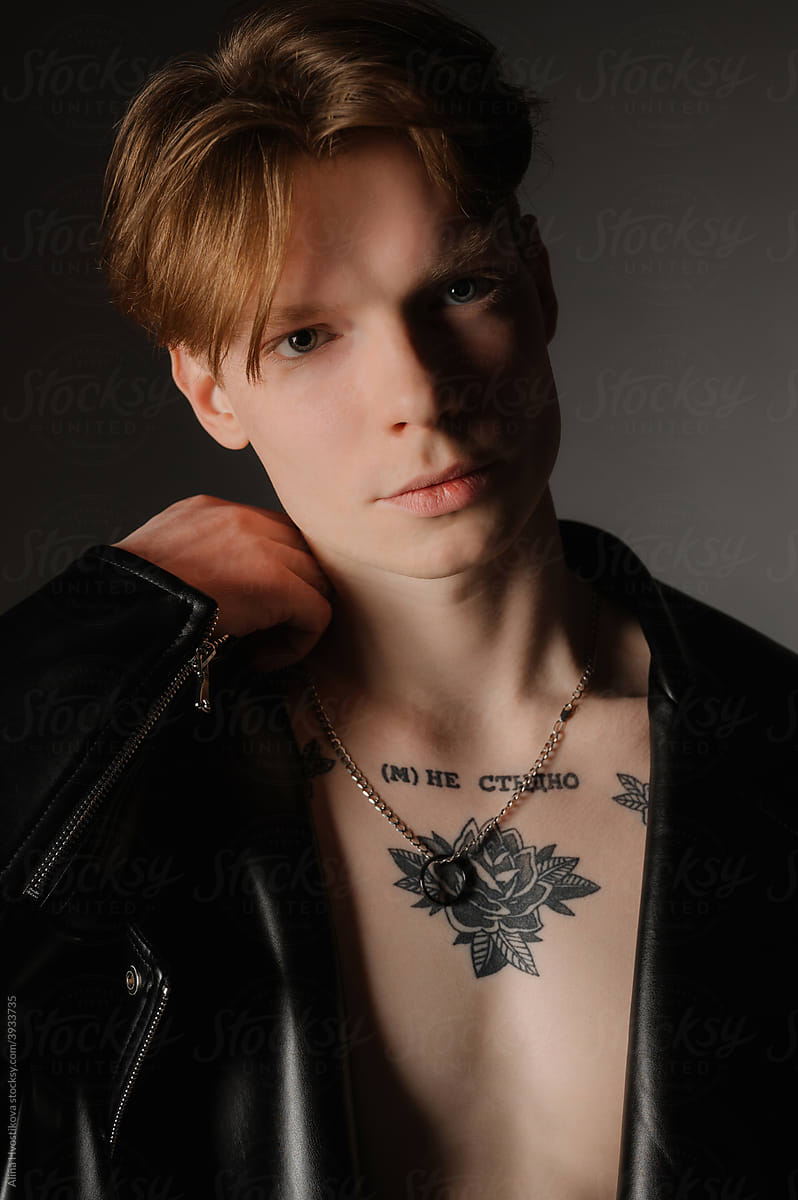 Cool young man in leather jacket on naked torso