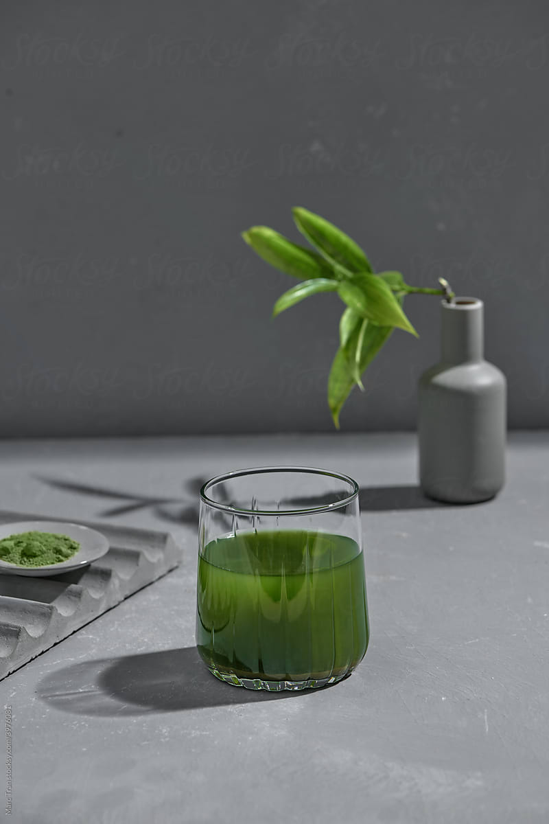 Matcha healthy drink in glass and bowl with powder