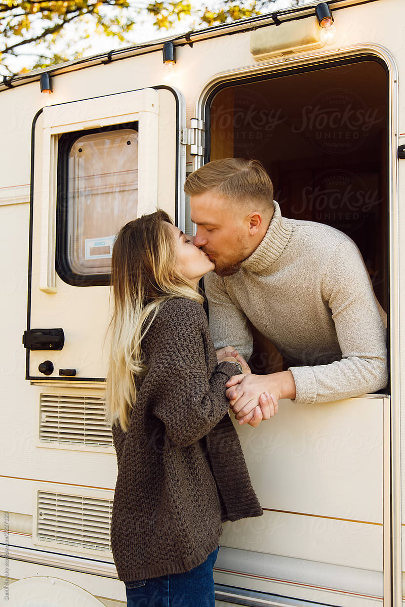 Young Couple Kissing Near Camper By Stocksy Contributor Danil Nevsky