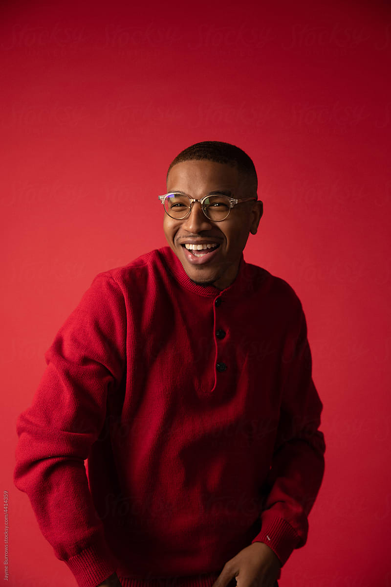 Man in Glasses Smiles in Red Sweater