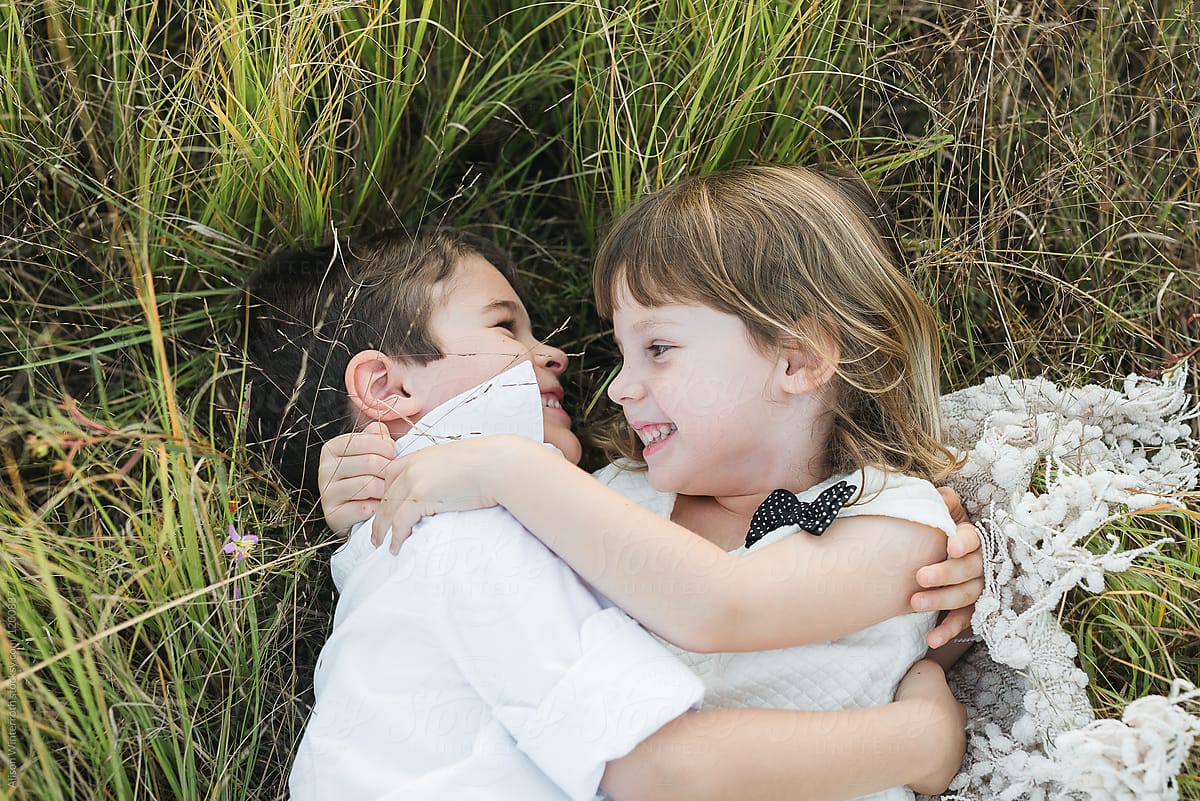 Two Children Lay In The Grass