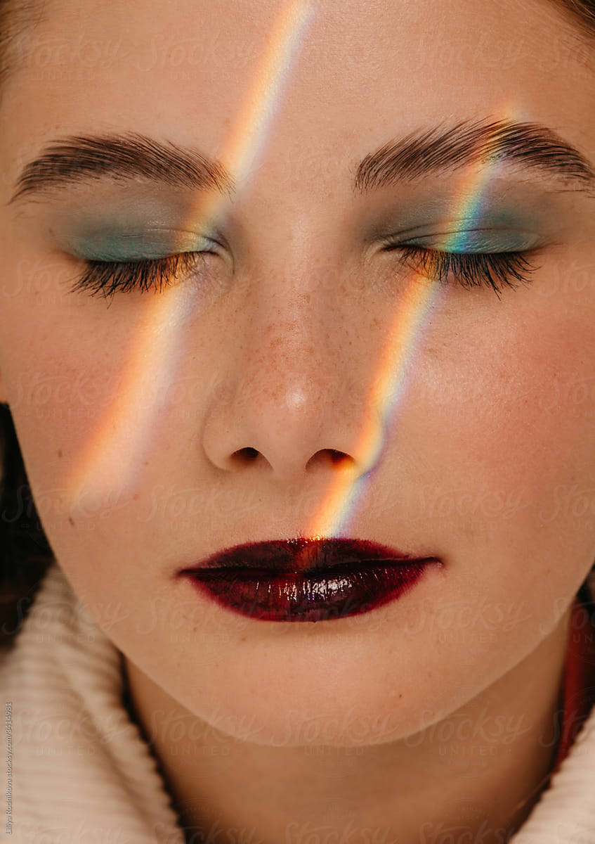Rainbow lines of light on pretty face