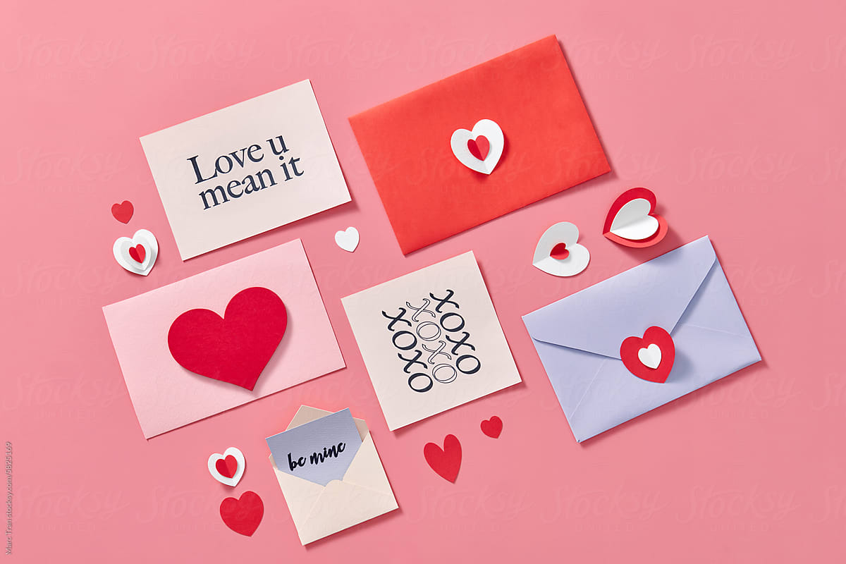 Envelope and Valentines hearts on pink background with romantic