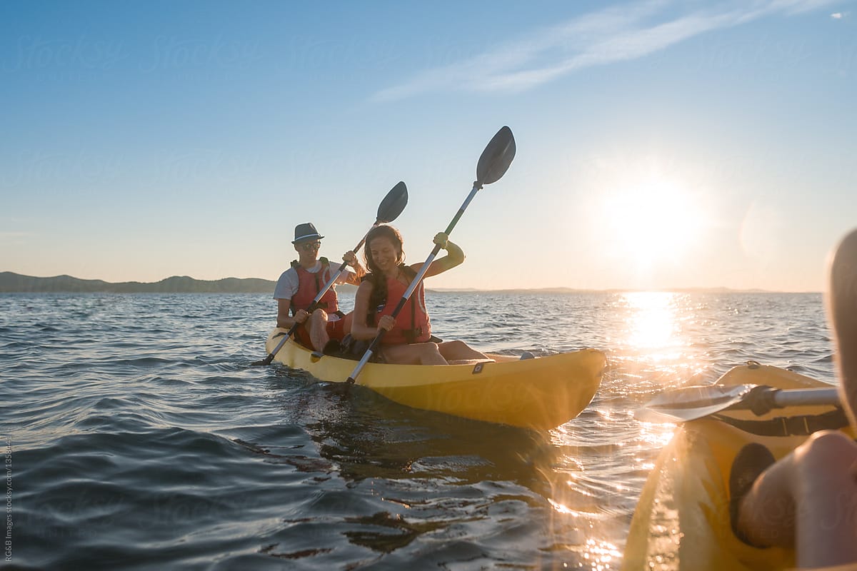 Couple of tourists in yellow kayak on the sea