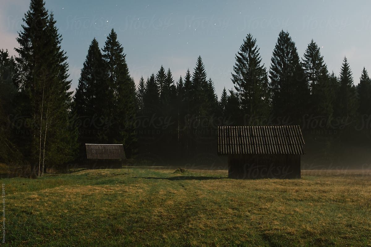 Two Wooden Cabins in Slovenian Alps at Midnight