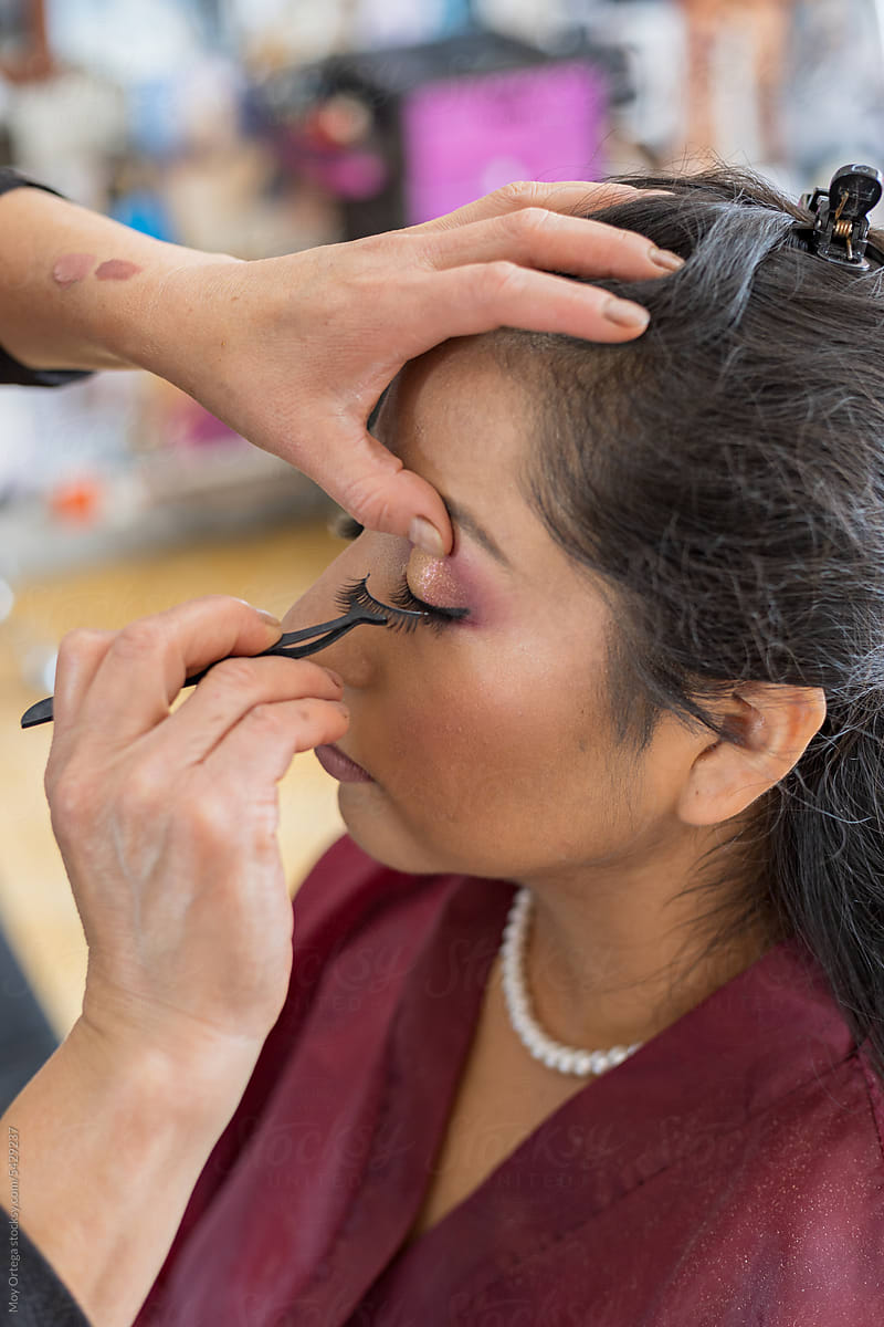 Makeup Artist Applying False Eyelashes To A Quinceanera