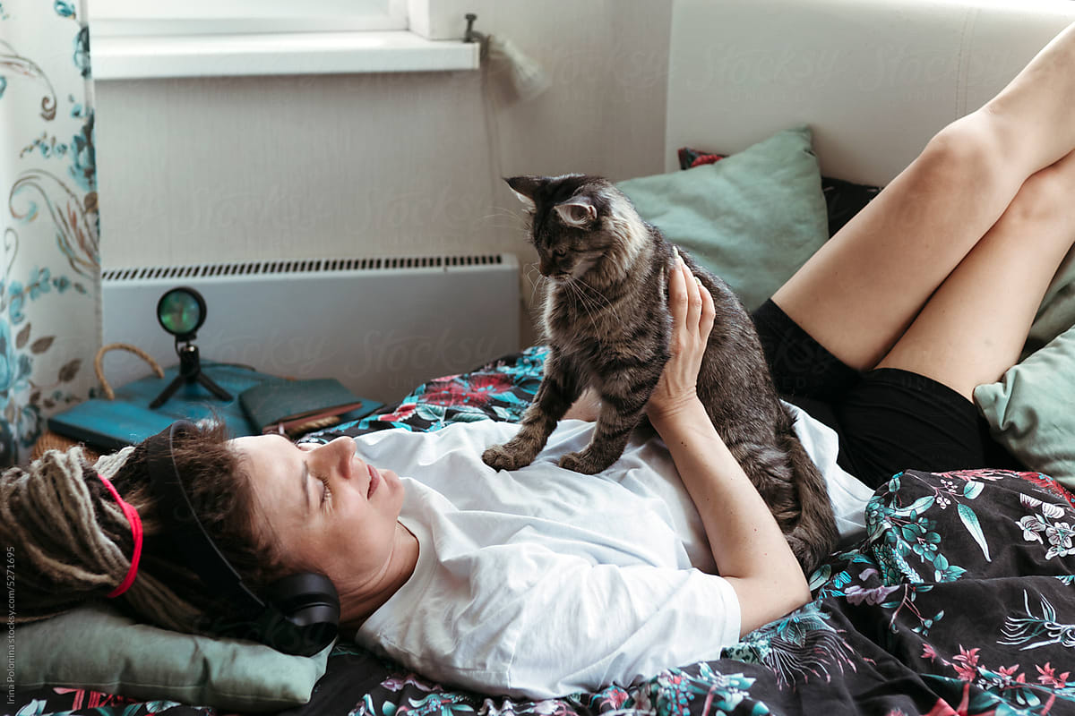 Happy female communicates with domestic cat.