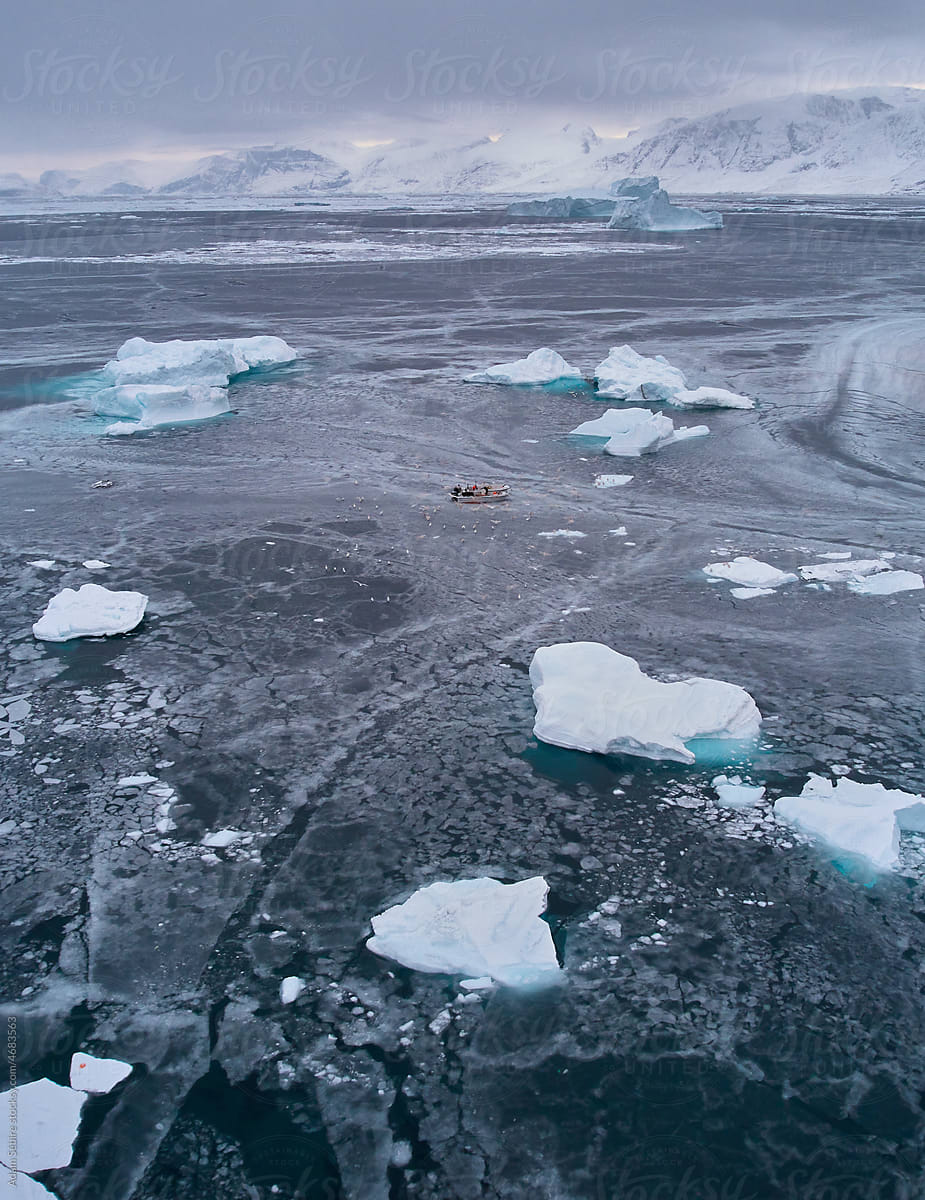 Indigenous Inuit boat fishing in Arctic sea ice