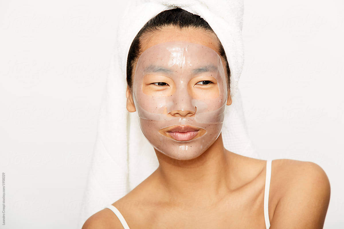 Young asian woman using facial gel mask