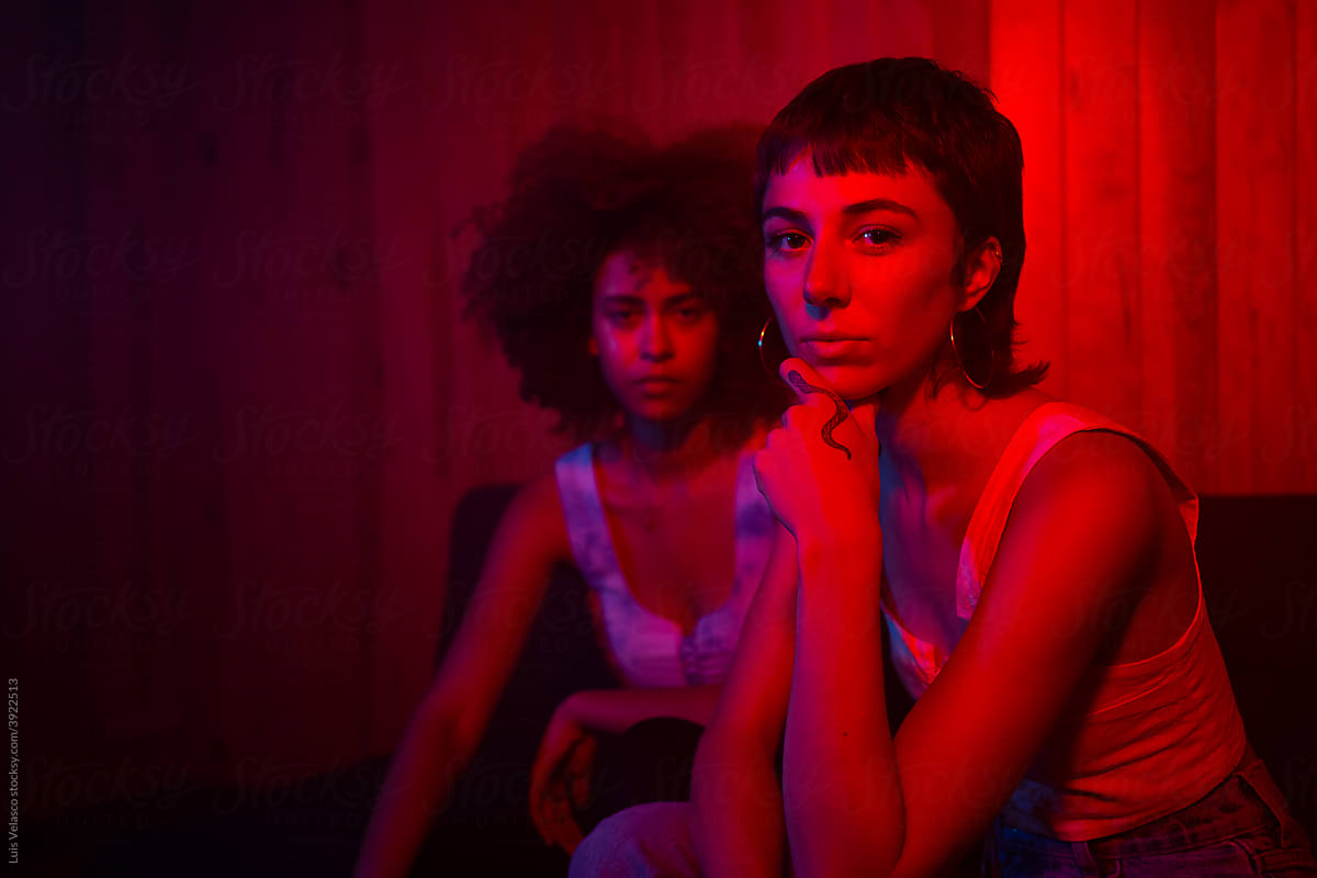 Portrait Of Two Alternative Girls With Red Lights.