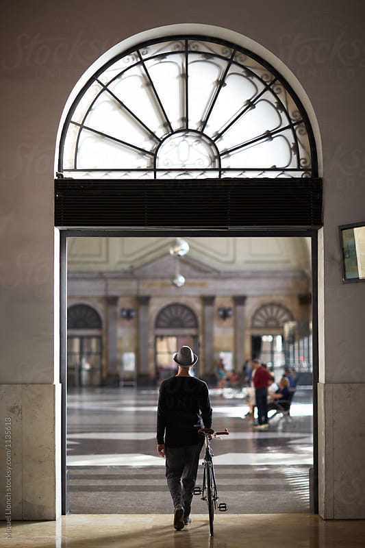 Man and bike in the hall of the train station
