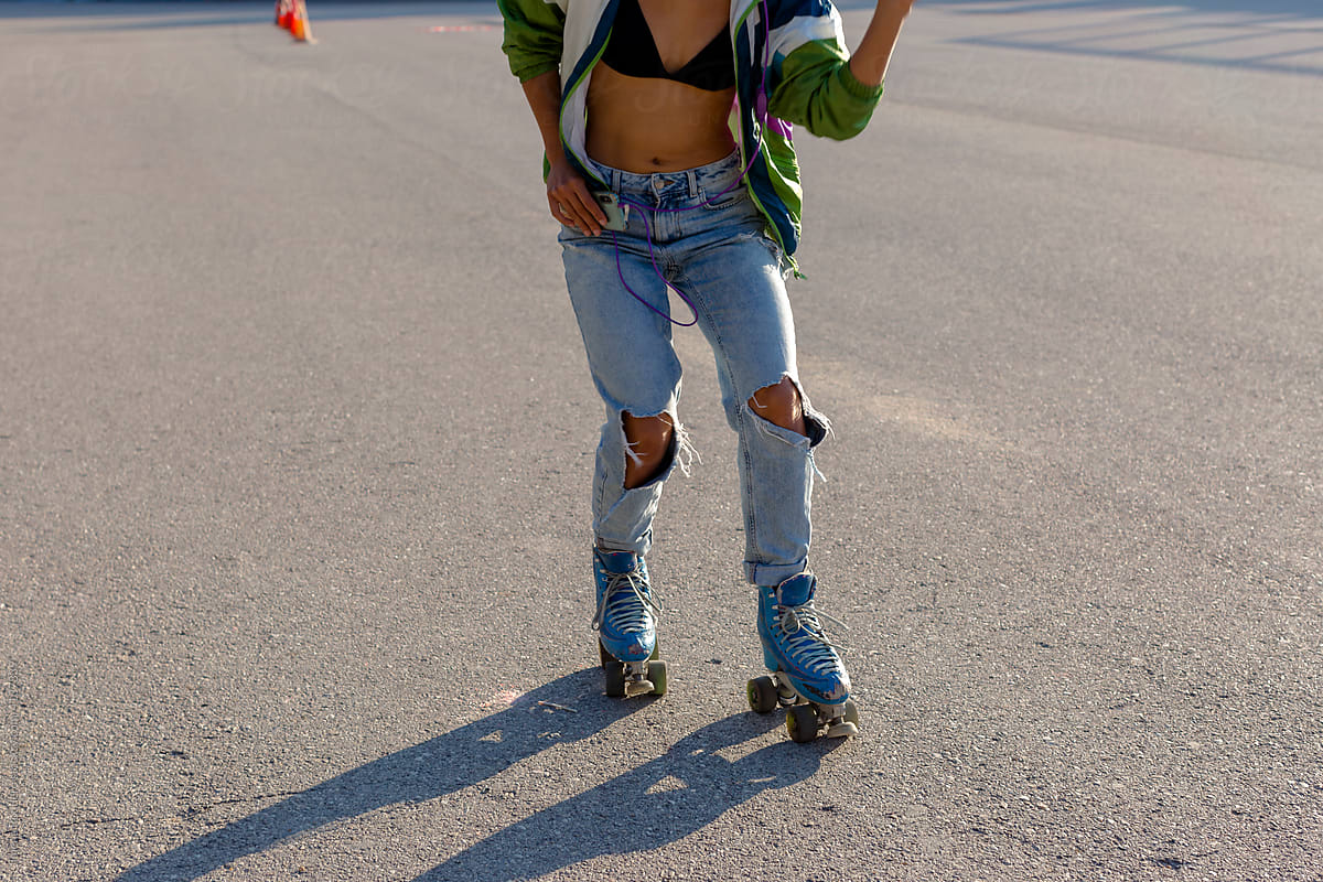 Roller-skater female body training in sunlight