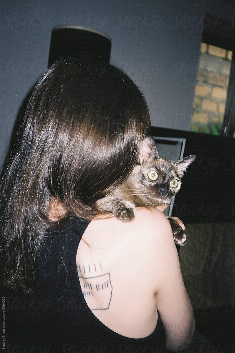 Young woman from the back and purebred cat
