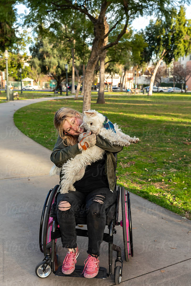 Woman in Wheelchair Hugs Dog