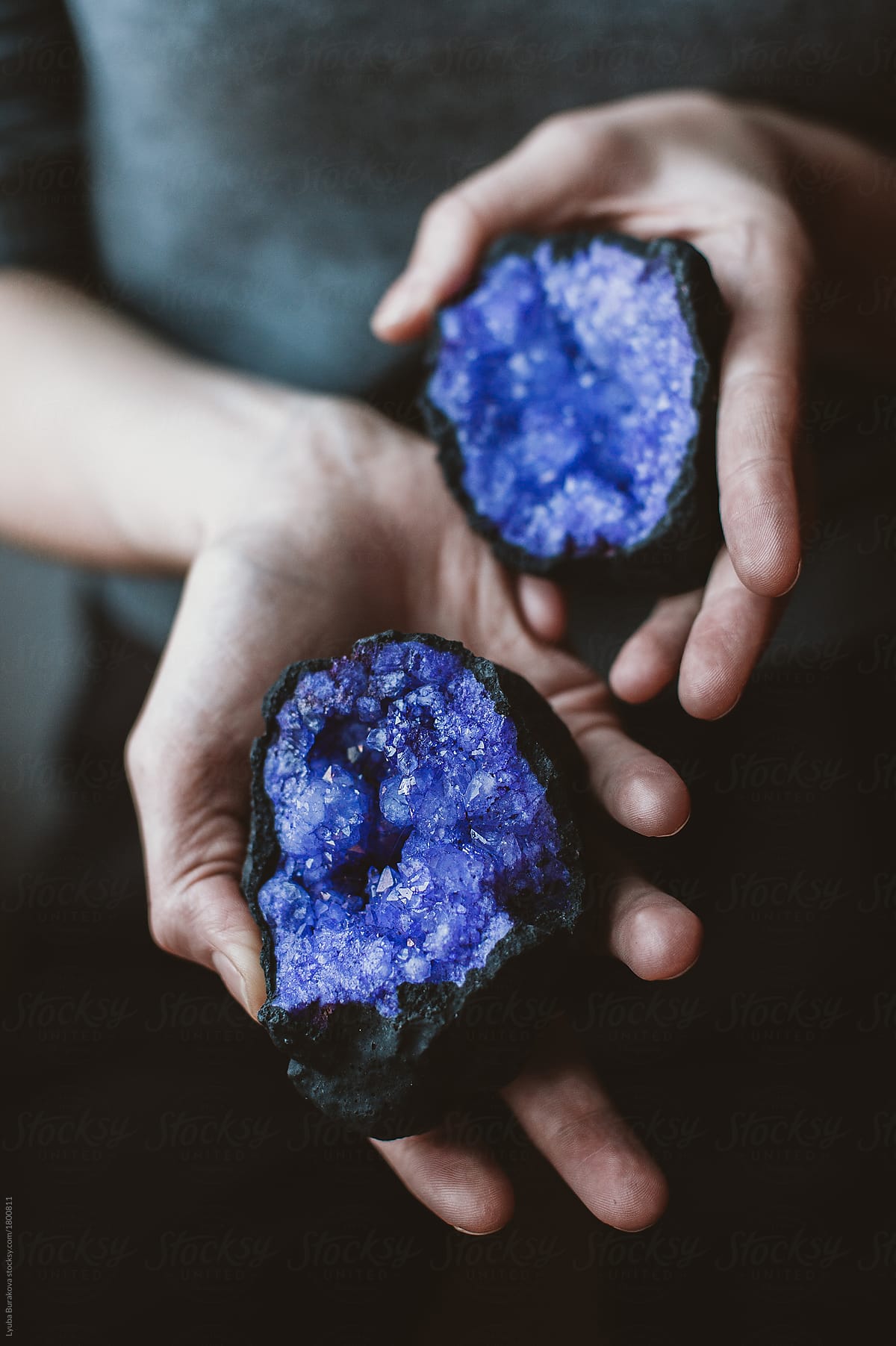Woman holding purple gemstones in her hands