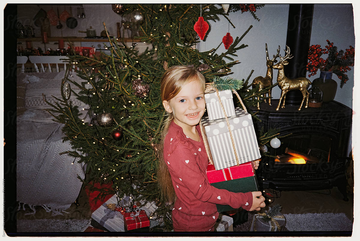 Child with stack of Christmas presents, ugc