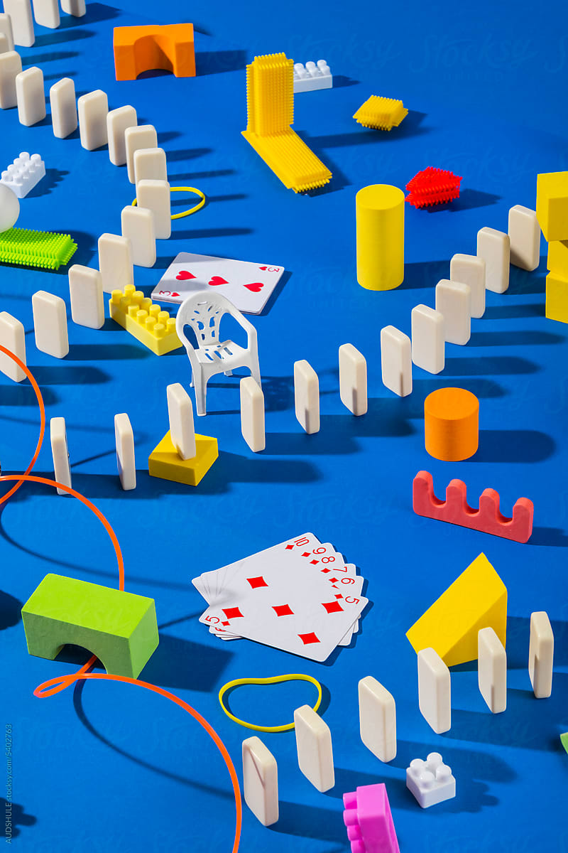 Abstractly arranged toys on blue.