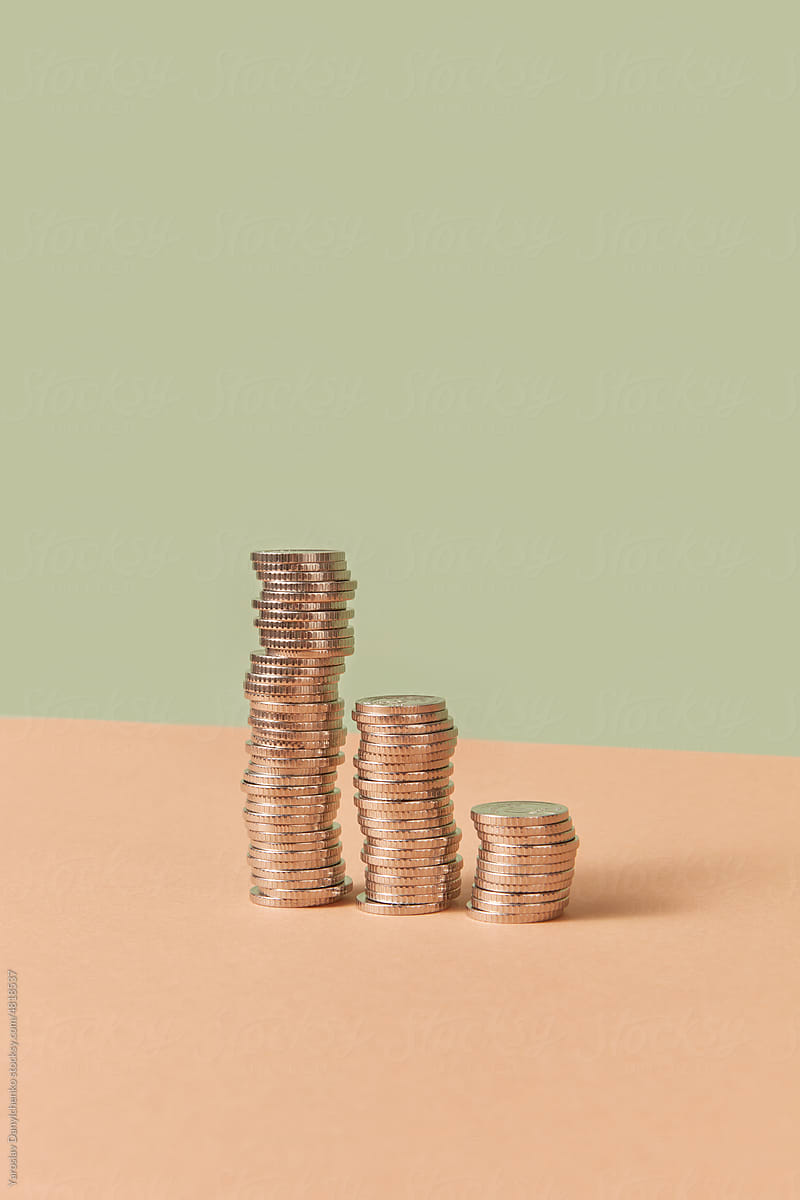 Stacks of cents on pastel background.
