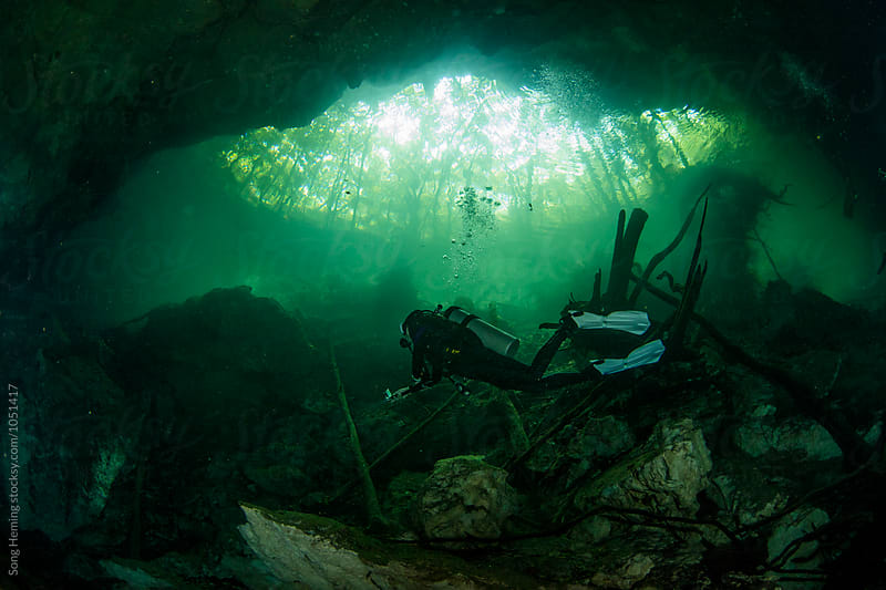 A scuba diver swimming in Mexico\'s  Cenote Chac-Mool