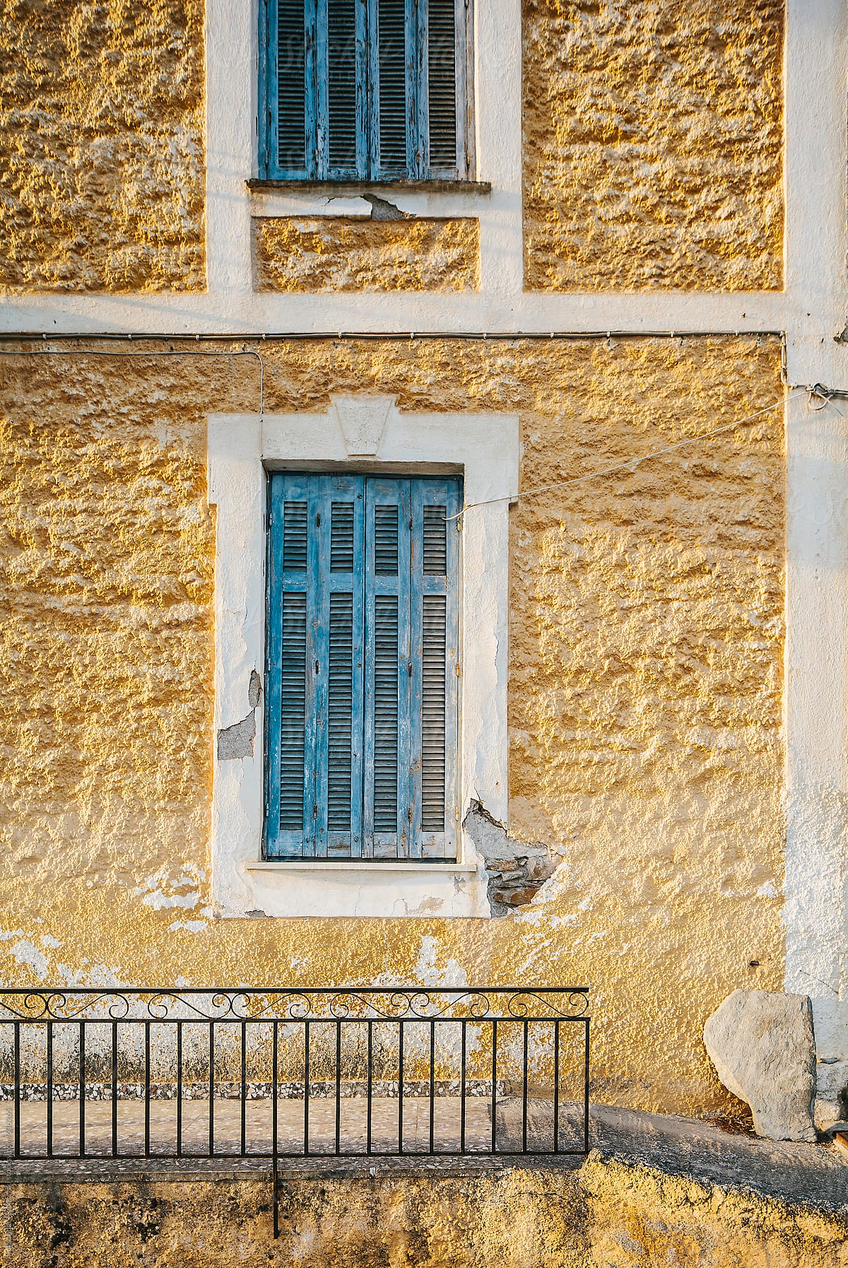 Detail of a blue windows in old building in Greece
