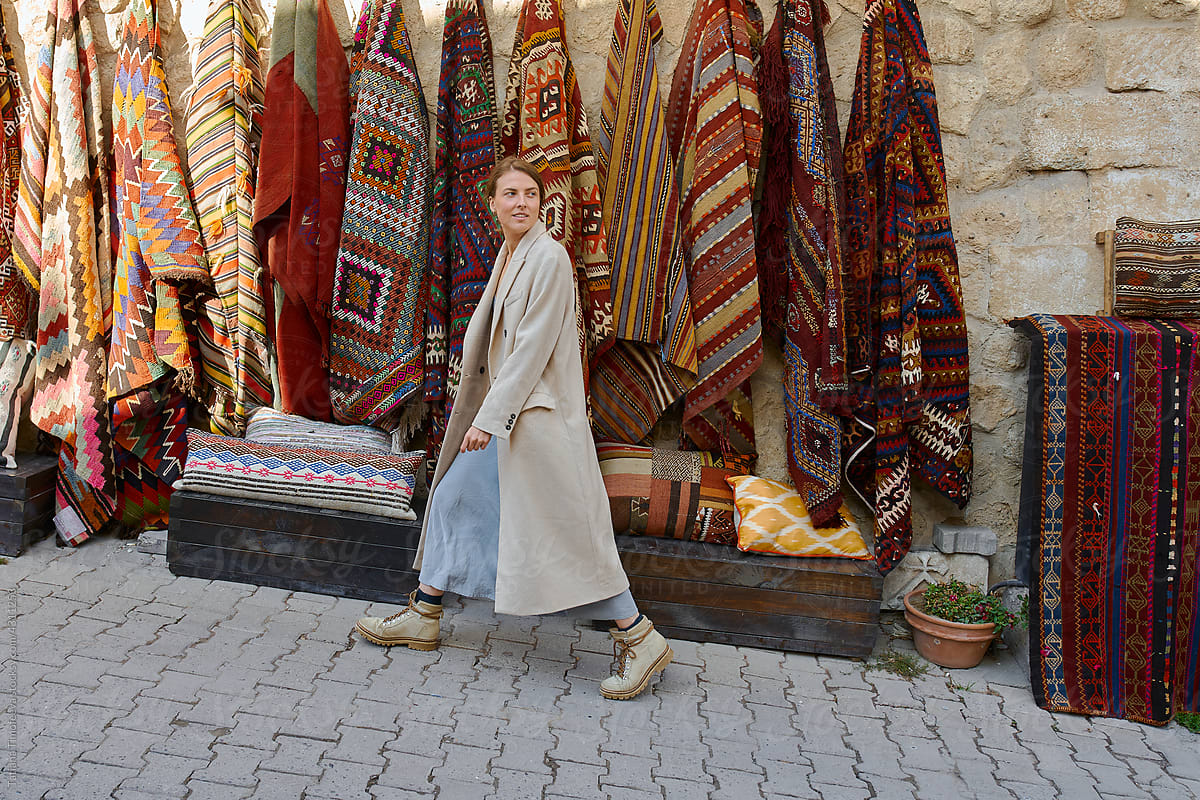 a woman walks through the old market