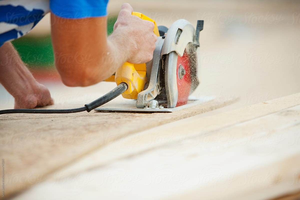 Construction: Carpenter Cutting Panel with Saw