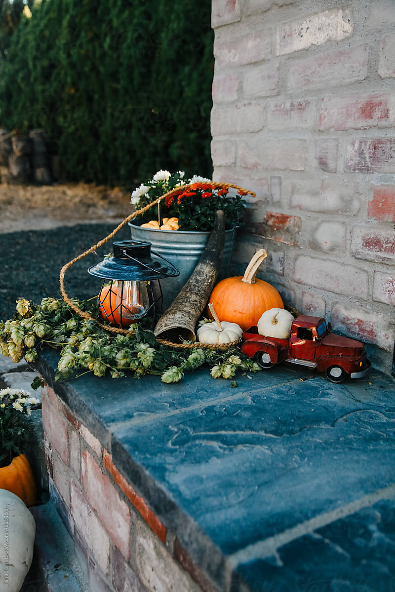fall decorations on outside fireplace hearth