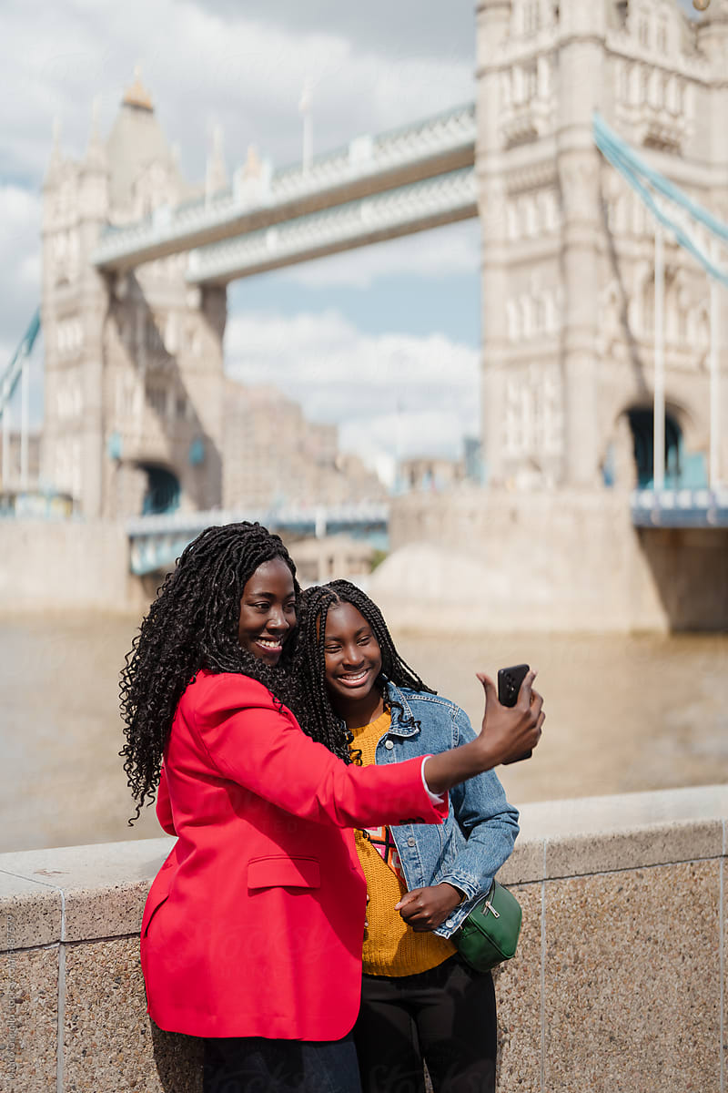 Mother and daughter taking a selfie in the city