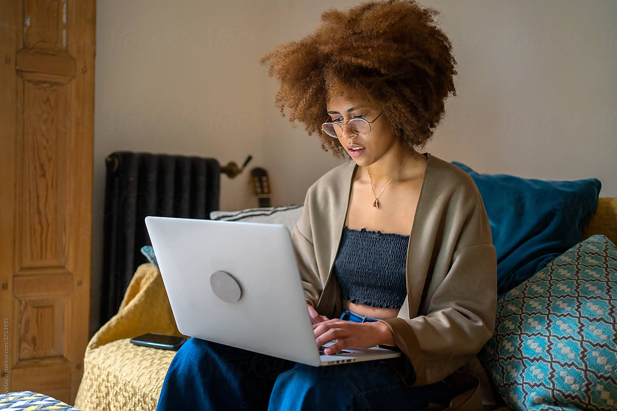 Young Woman With Glasses Working From Home With Laptop.
