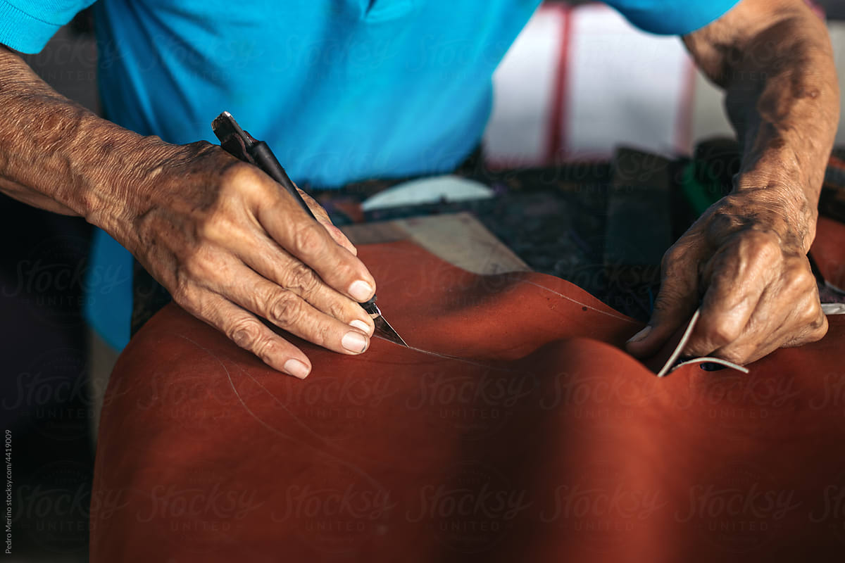 Close up of a shoemaker working on a sole