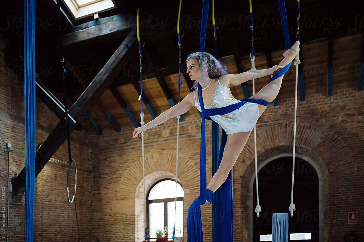 Circus Woman Performer Training Doing Acrobatics In The Air.