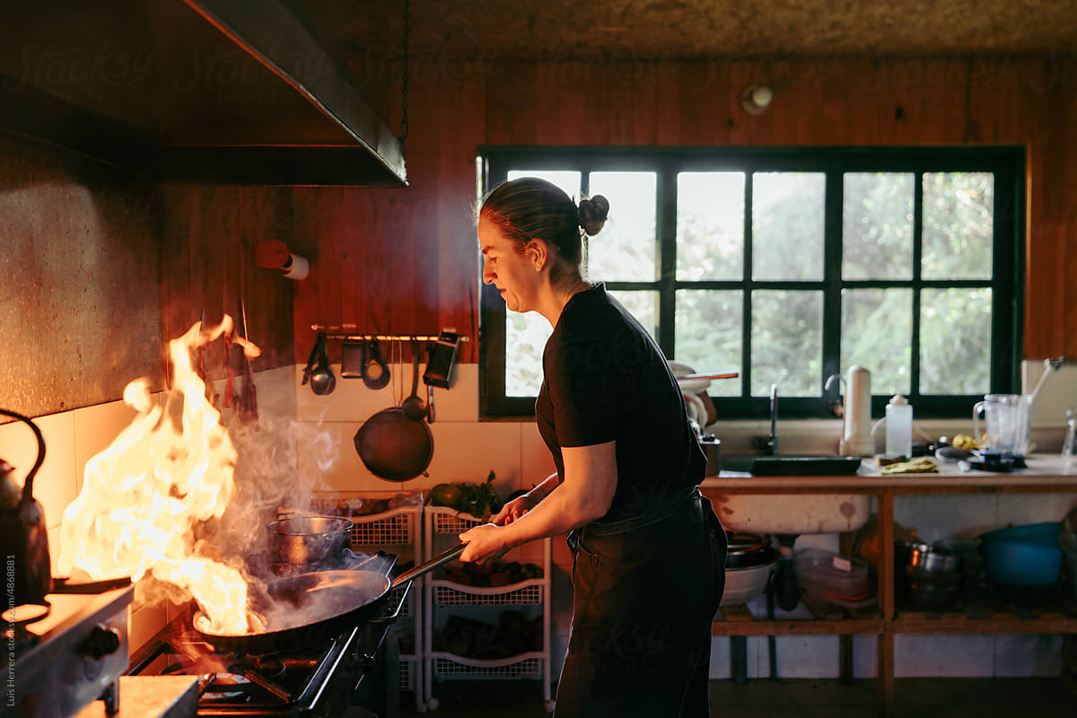 woman chef cooking at her kitchen