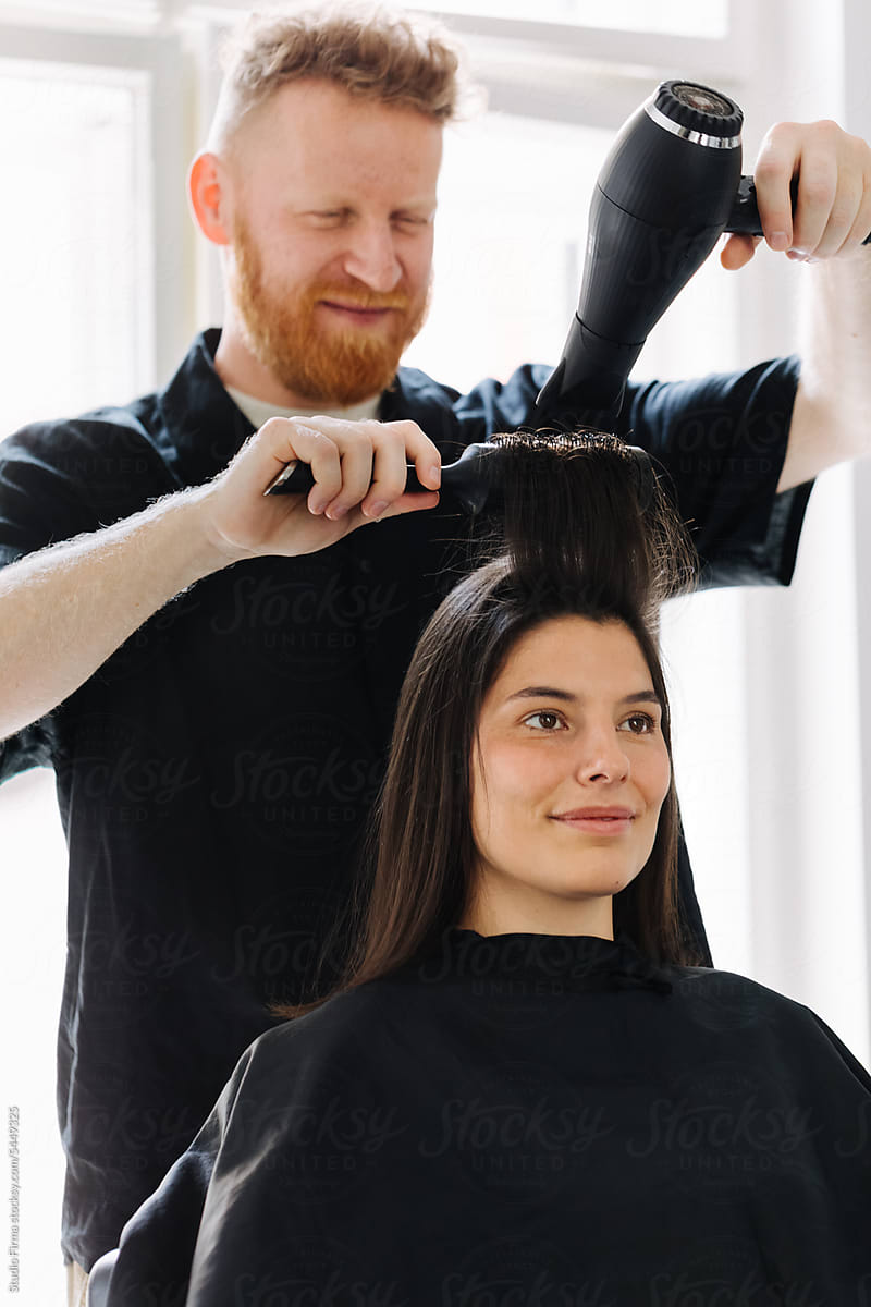 Hairdresser Drying Woman's Hair