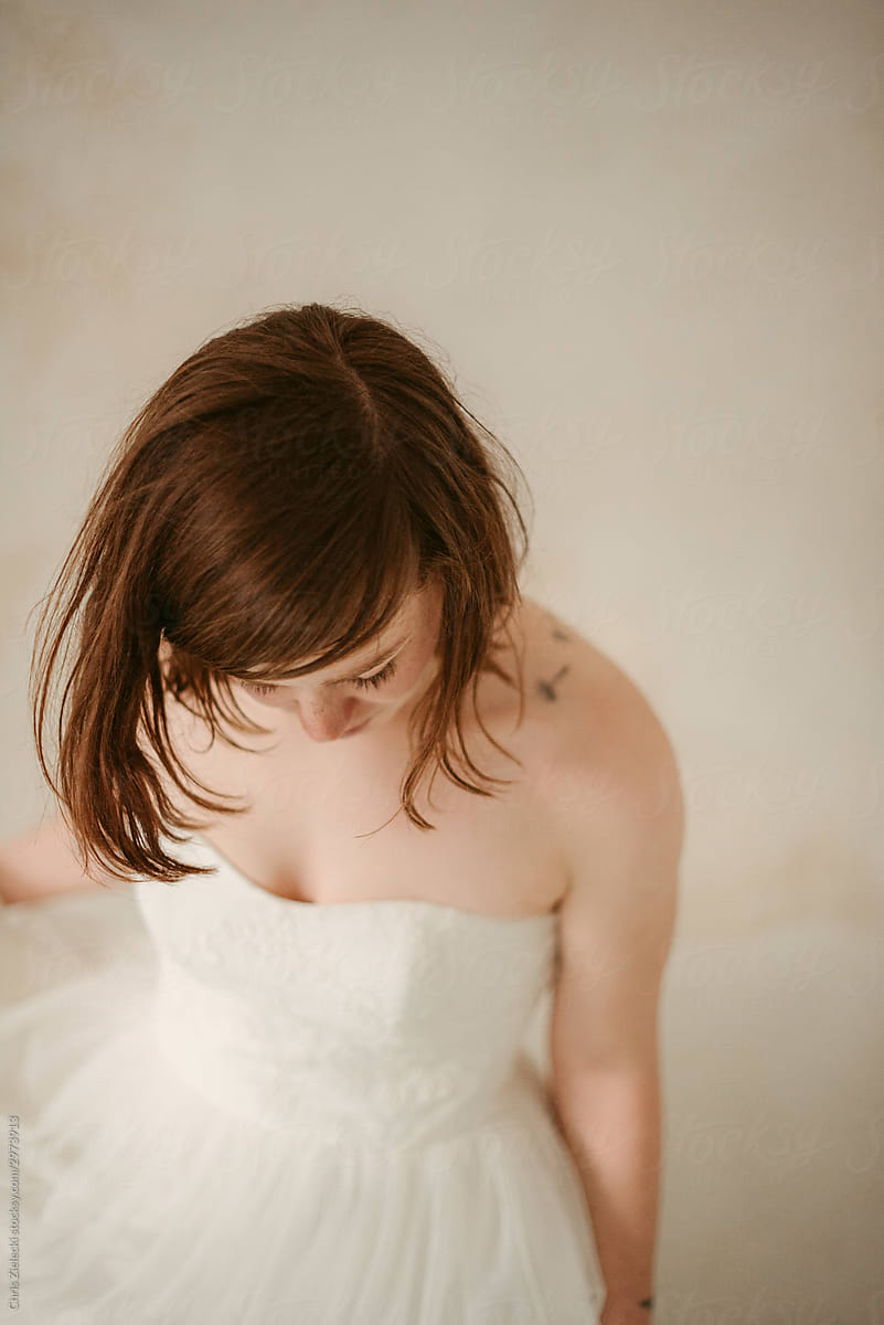 Soft tattooed bride in lush wedding dress