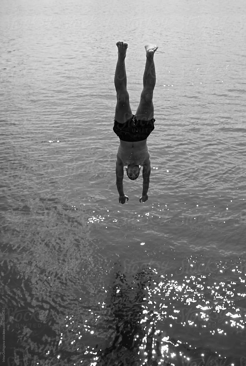 Young guy diving into the water outdoor