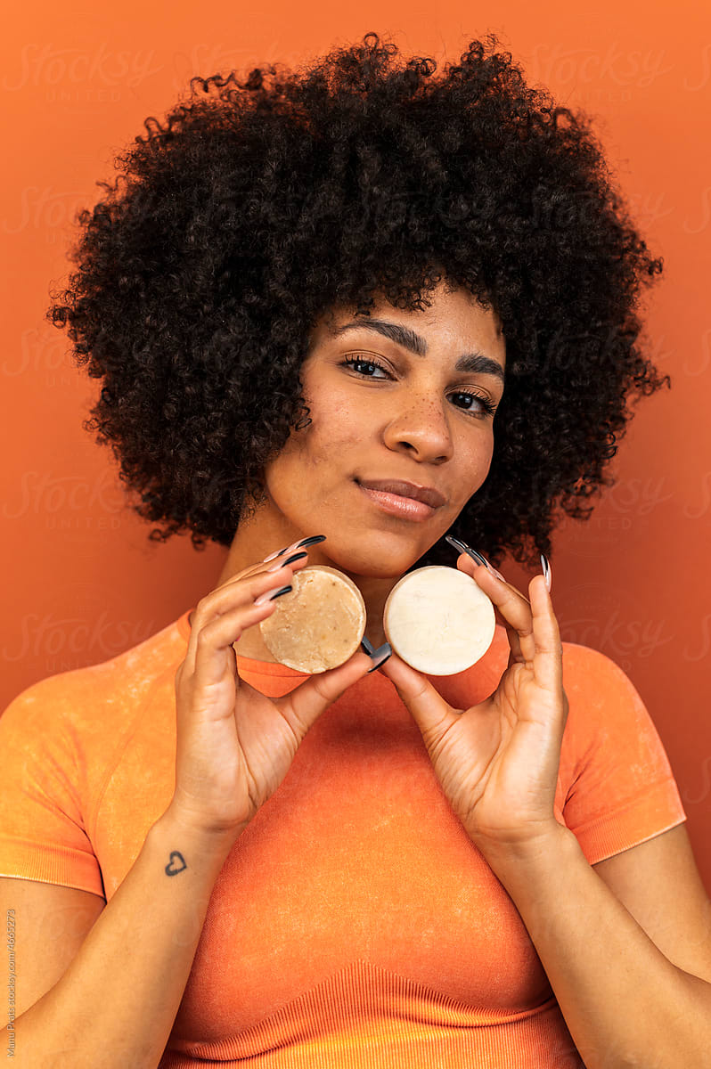 Brown skinned woman displaying handmade soap