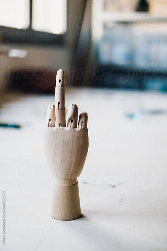 Mannequin hand showing the middle finger