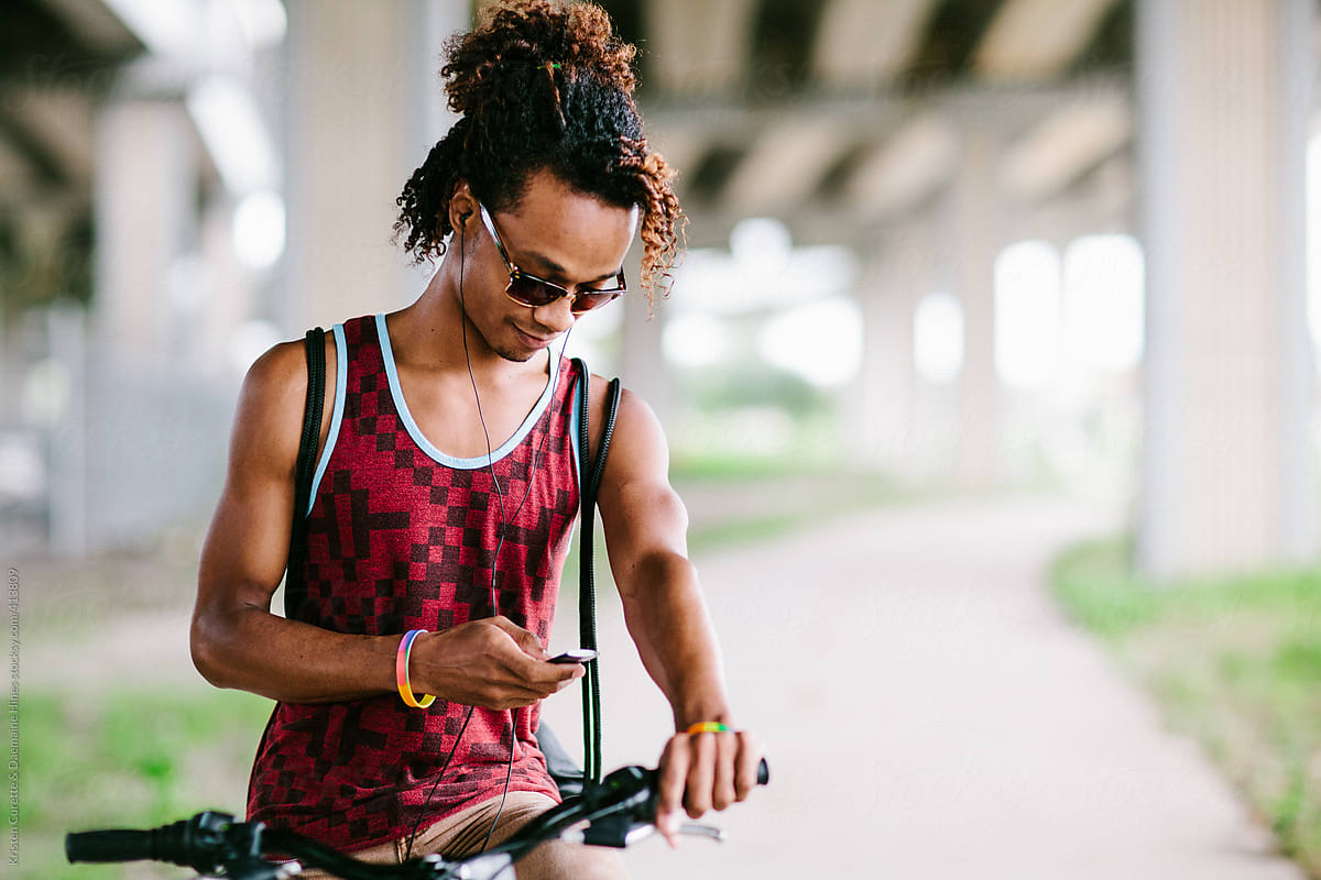 Young man listening to music on his bicycle.