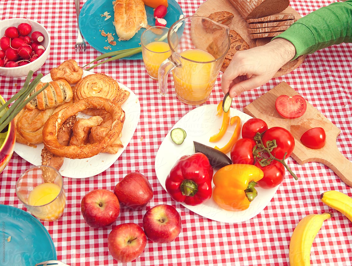 Table full of colorful breakfast picnic food.